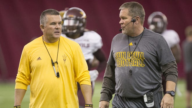 The Arizona State University head coach Todd Graham talks with Shawn Slocum, Associate head coach (Special Teams Coord./OLBs) during football practice in the Dickey Dome at their Tempe, Az. campus on Friday, August 8, 2015.