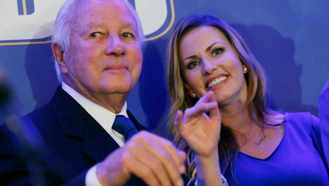 Former Louisiana governor Edwin Edwards waves with his wife Trina Scott Edwards as they arrive onstage with family and supporters for Louisiana Gov.-elect John Bel Edwards, at his election night watch party in New Orleans, Saturday, Nov. 21, 2015. John Bel Edwards won the runoff election for Louisiana governor Saturday, defeating the once-heavy favorite, Republican David Vitter, and handing the Democrats their first statewide victory since 2008. (AP Photo/Gerald Herbert)