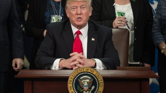 President Donald Trump speaks after signing an executive order to start the Mexico border wall project at the Department of Homeland Security facility in Washington, DC, on January 25, 2017.