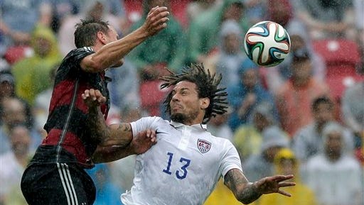 Germany's Benedikt Hoewedes, left, and United States' Jermaine Jones go for a header during the group G World Cup soccer match between the USA and Germany at the Arena Pernambuco in Recife, Brazil, Thursday, June 26, 2014. (AP Photo/Matthias Schrader)