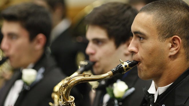 Tenor saxophonist Perry Groves warms up with the McNary Wind Ensemble before performing during the OSAA 6A band championships, in the LaSells Stewart Center, on Saturday, May 17, 2014.