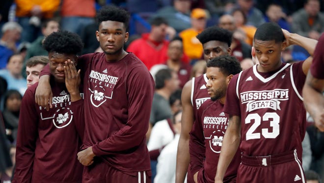 Members of Mississippi State watch as teammate Nick Weatherspoon is worked on by medical personnel after he was injured going up for a layup and landing hard on the court during the second half of an NCAA college basketball game against Tennessee in the quarterfinals of the Southeastern Conference tournament Friday, March 9, 2018, in St. Louis. Weatherspoon was taken off on a stretcher. (AP Photo/Jeff Roberson)