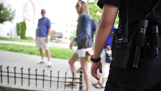 Metro Nashville police officers patrol near the Church Street Park in Nashville, Tenn., Thursday, May 8, 2014.