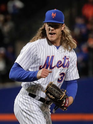 Noah Syndergaard reacts after striking out the Miami Marlins' Dee Gordon with two runners on base to end the top of the fifth at Citi Field on Sunday night.