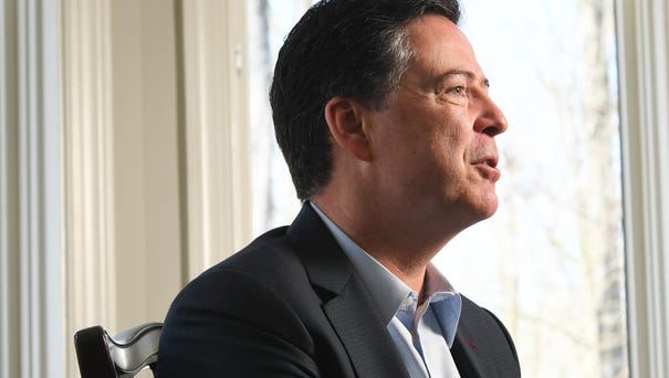 Former FBI director James Comey sits for an...