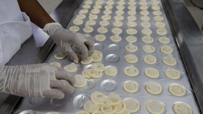 Condoms made with native latex are ready to be packed at the Natex factory that produces around 100 million condoms per year for the Brazilian Health Ministry in Xapuri, Acre State on October 7, 2014.