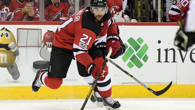 New Jersey Devils right wing Kyle Palmieri (21) passes the puck during the second period of an NHL hockey game against the Colorado Avalanche Saturday, Oct. 7, 2017, in Newark, N.J. (AP Photo/Bill Kostroun)