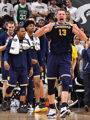Moritz Wagner grabs his jersey as the celebration begins for Michigan after its win over Michigan State on Saturday.