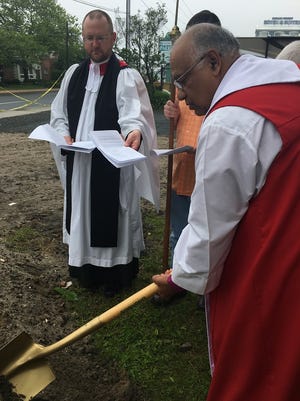 In this Saturday, May 13, 2017 photo, from left, the Rev. Matthew Justin D'Amario, rector, and Bishop Santosh Marray break ground on a new building at St. Paul's by the Sea Episcopal Church.