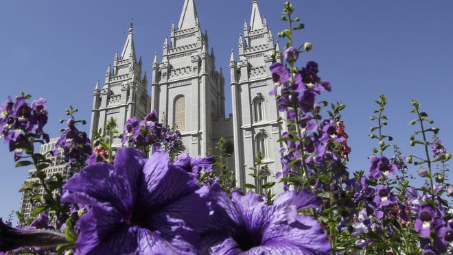 In this Sept. 3, 2014, file photo, shows flowers blooming in front of the Salt Lake Temple in Temple Square, in Salt Lake City. Mormon missionaries will remain in Russia despite the country’s new anti-terrorism law, which will put greater restrictions on religious work starting later this month.