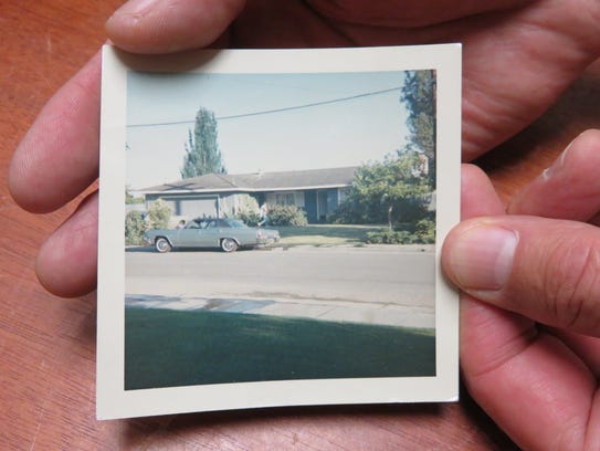 Dave Reddix holds a picture of the "Waldomobile," a