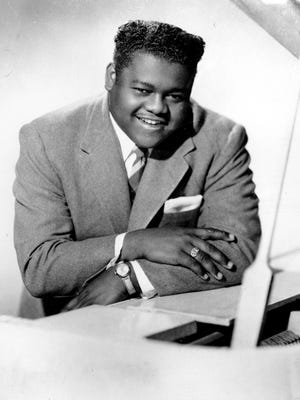 This 1956 file photo shows singer, composer and pianist Fats Domino.  The amiable rock 'n' roll pioneer whose steady, pounding piano and easy baritone helped change popular music even as it honored the grand, good-humored tradition of the Crescent City, has died. He was 89. Mark Bone, chief investigator with the Jefferson Parish, Louisiana, coroner's office, said Domino died Tuesday, Oct. 24, 2017.  (