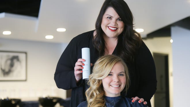 Kortney Norris, stylist, and owner of the new Salon 1|4, 1407 E. 86th St. in Indianapolis poses for a photo with longtime friend and hair model Emily Schwalbach after giving her a quick do on Monday, Jan. 29, 2018. Norris will also soon be known for doing the brides' hair for the TV show "Married at First Sight." 