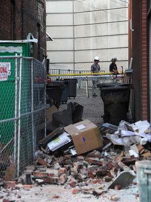 Bricks and other small building material fell from the roof of a building under construction near 310 Broadway, crashing into the window at Savannah's Candy Kitchen Wednesday April 8, 2015.