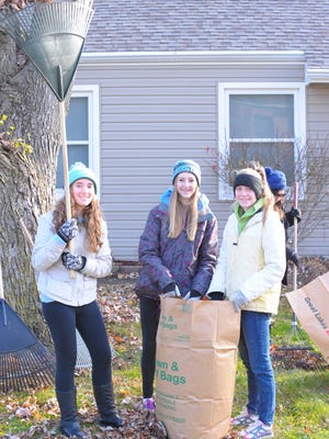 
Plymouth Girl Scout troop members Gina Hubbell, Sarah Zrull and Sarah Griffiths help clean yards along Elmhurst Street.
