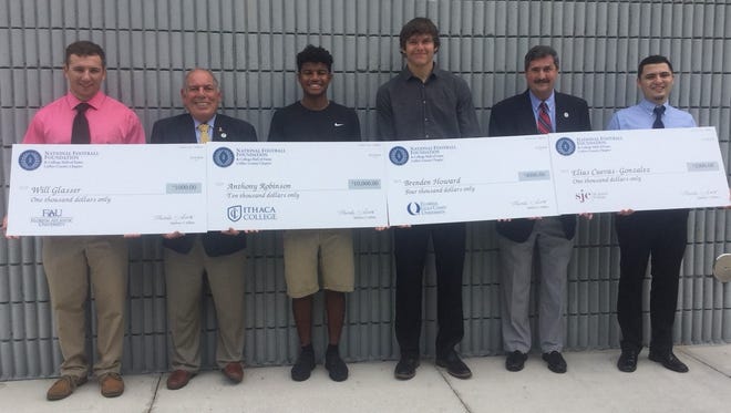 The winners of the National Football Foundation Collier County Chapter's 2018 scholarships display their ceremonial checks. From left: St. John Neumann's Will Glasser, chapter president Matt Sellitto, Golden Gate's Anthony Robinson, Marco Island Academy's Brenden Howard, chapter secretary Tom Stuart, Immokalee's Elias Cuevas.