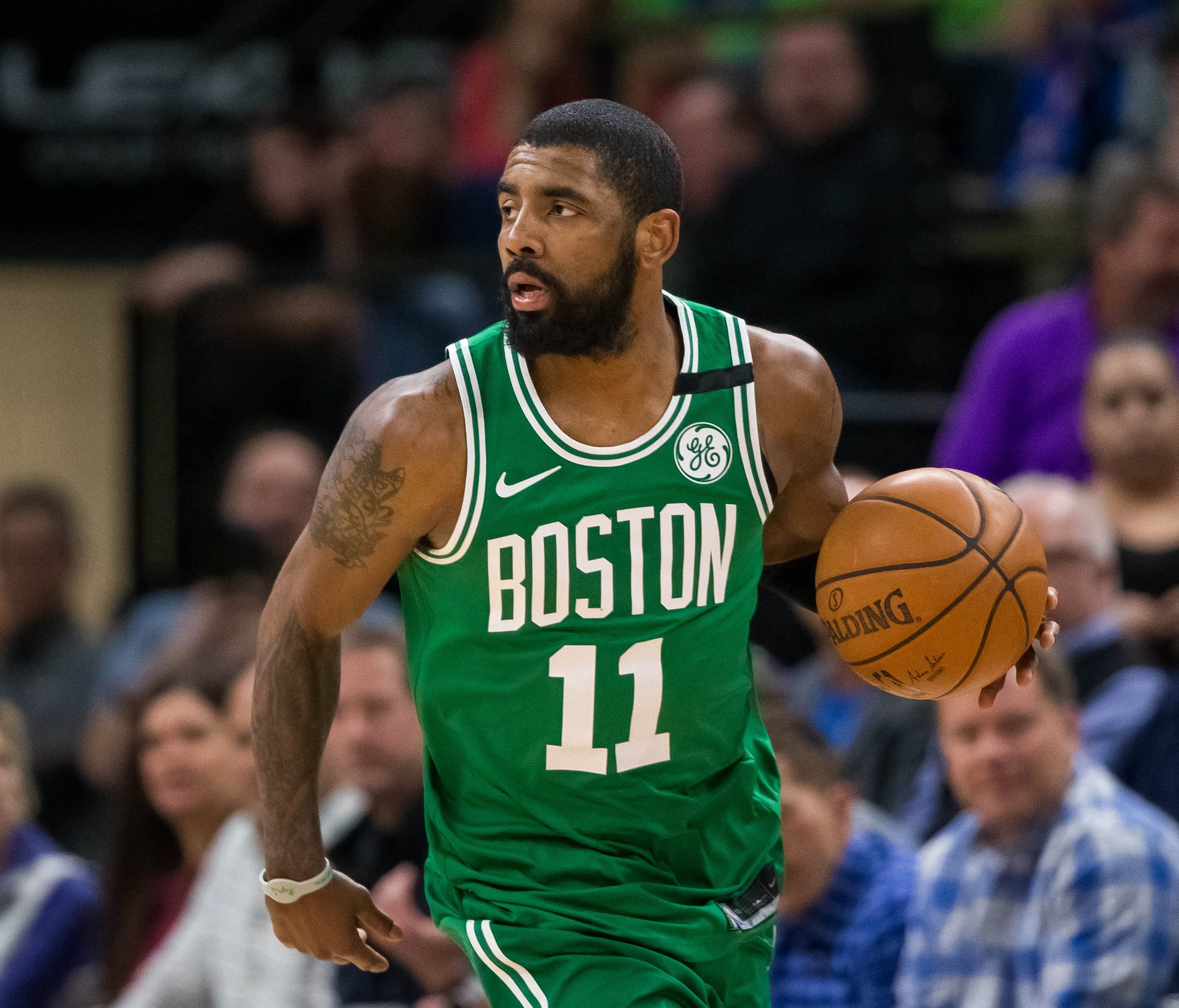 Boston Celtics guard Kyrie Irving (11) dribbles in the third quarter against Minnesota Timberwolves at Target Center.