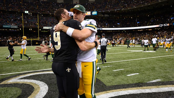 Green Bay Packers quarterback Aaron Rodgers (right) hugs New Orleans Saints quarterback Drew Brees after their 2014 game at the Superdome in New Orleans. (USA TODAY NETWORK-Wisconsin)