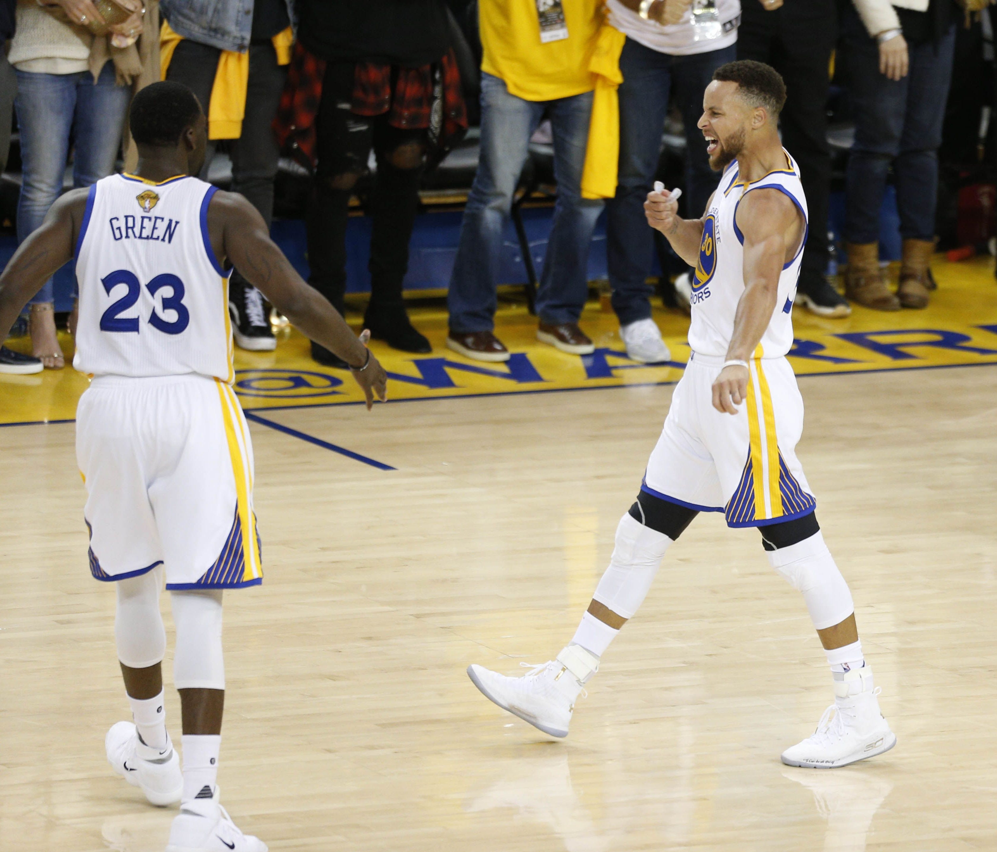 Golden State Warriors guard Stephen Curry (30) celebrates with forward Draymond Green (23) against the Cleveland Cavaliers during the second half in game two of the 2017 NBA Finals at Oracle Arena.