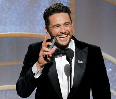 This image released by NBC shows James Franco, center, accepting the award for best actor in a motion picture comedy or musical for his role in 