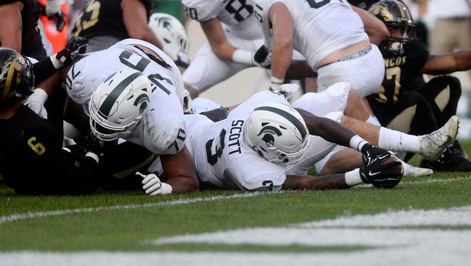 Michigan State's LJ Scott stretches across the goal line for a touchdown during the fourth quarter on Saturday, Sept. 9, 2017, at Spartan Stadium in East Lansing.