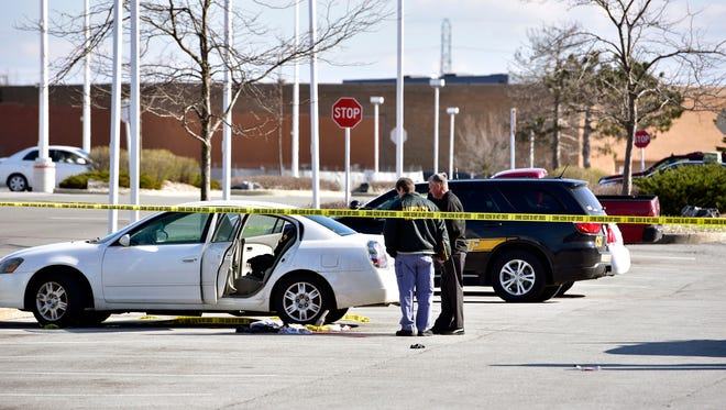 Police tape surrounds the scene where a 3-year-old girl accidentally shot and wounded her pregnant mother in a car parked outside a northwestern Indiana thrift store on Tuesday, April 17, 2018. The shooting happened Tuesday afternoon in Merrillville, Ind., as the girl, a 1-year-old boy and her mother waited in the car while the woman's boyfriend was inside the store. Police say the man is the girl's father and apparently left the loaded gun in the car.