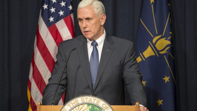Indiana Gov. Mike Pence speaks to press members after signing his state’s Religious Freedom Restoration Act on Thursday.