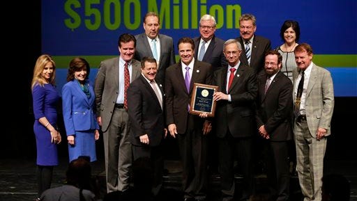New York Gov. Andrew Cuomo poses for a photo with representatives of the Finger Lakes Regional Economic Development Council during an economic development awards ceremony on Thursday, Dec. 10, 2015, in Albany, N.Y.