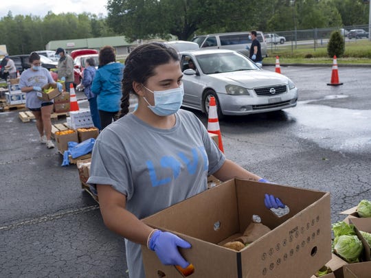 Residents lined up to receive boxes of food at Living Water Baptist Church in Longs, S.C., on Monday. Local organizations stepped in help after Horry County Schools postponed its lunch program this week because some school workers tested positive for the coronavirus.