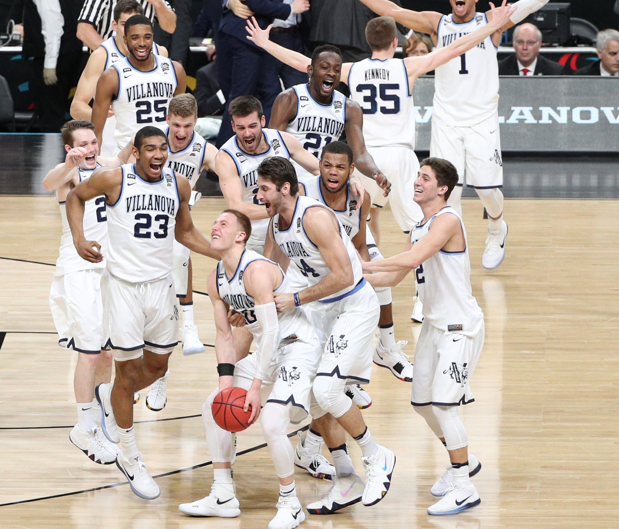 Villanova players celebrate with teammates after defeating Michigan to win the national title in the 2018 NCAA tournament.