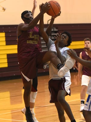 Licking Heights' Chancelor Burns takes a shot against defense from Christian Moore during intrasquad scrimmage during a practice on Tuesday, Nov. 14, 2017. 