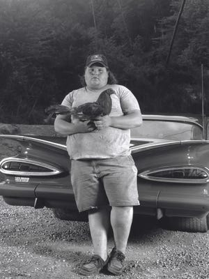“The Cock Fighter” is among Shelby Lee Adams’ portfolio of powerful images created from more than four decades of visiting, photographing and collaborating with families in Appalachia.