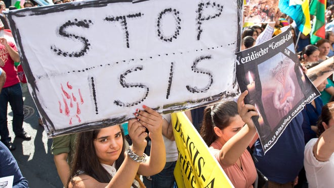 Kurds and Yazidi take part in a rally in Frankfurt, Germany, on Aug. 9, 2014, protesting the invasion of large parts of the Iraq by the jihadist group Islamic State (IS).