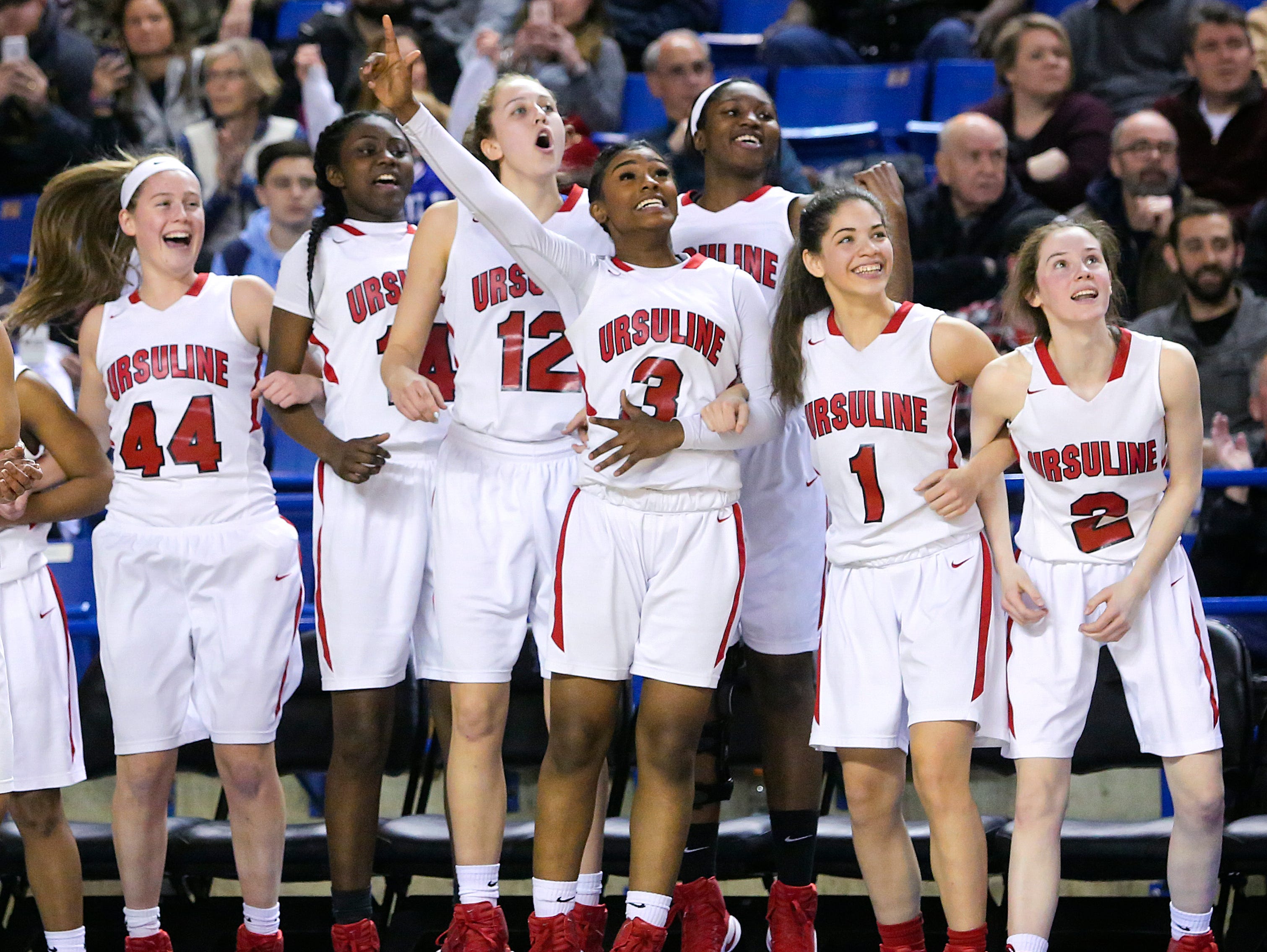 Ursuline starters and contributors (from left) Lindsay Brown, Kryshell Gordy, Olivia Mason, Yanni Hendley-McCalla, Kay Wulah, Alisha Lewis and Maggie Connolly wait for the final seconds to come off the clock in the second half of the Raiders' 54-32 win in the DIAA state tournament title game at the Bob Carpenter Center Friday.