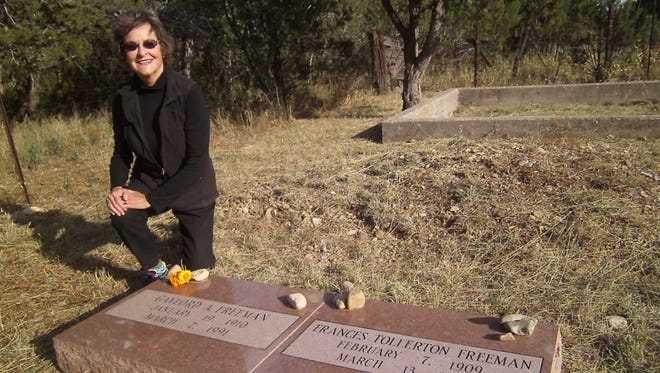 Clara Freeman Farah places chrysanthemums on the graves of her parents Gaylord and Frances Freeman who, with the Henns and Robert O. Anderson, established the LIncoln Heritage Trust.