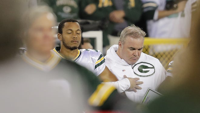 Green Bay Packers quarterback Brett Hundley and coach Mike McCarthy stand for the national anthem before the game against the Chicago Bears Thursday, Sept. 28, 2017 at Lambeau Field in Green Bay, Wis.
