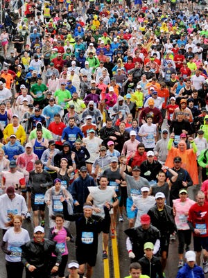 In this file photo, runners cross the starting line during the Country Music Marathon on April 27, 2013.