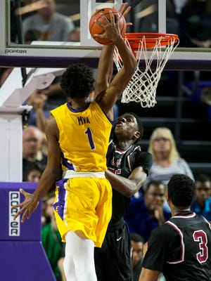 Memphis East's Malcolm Dandridge blocks a shot by Montverde Academy's Rechon Black in the finals of the 44th Annual City of Palms Classic on Wednesday, December 21, 2016, at Suncoast Credit Union Arena in Fort Myers.