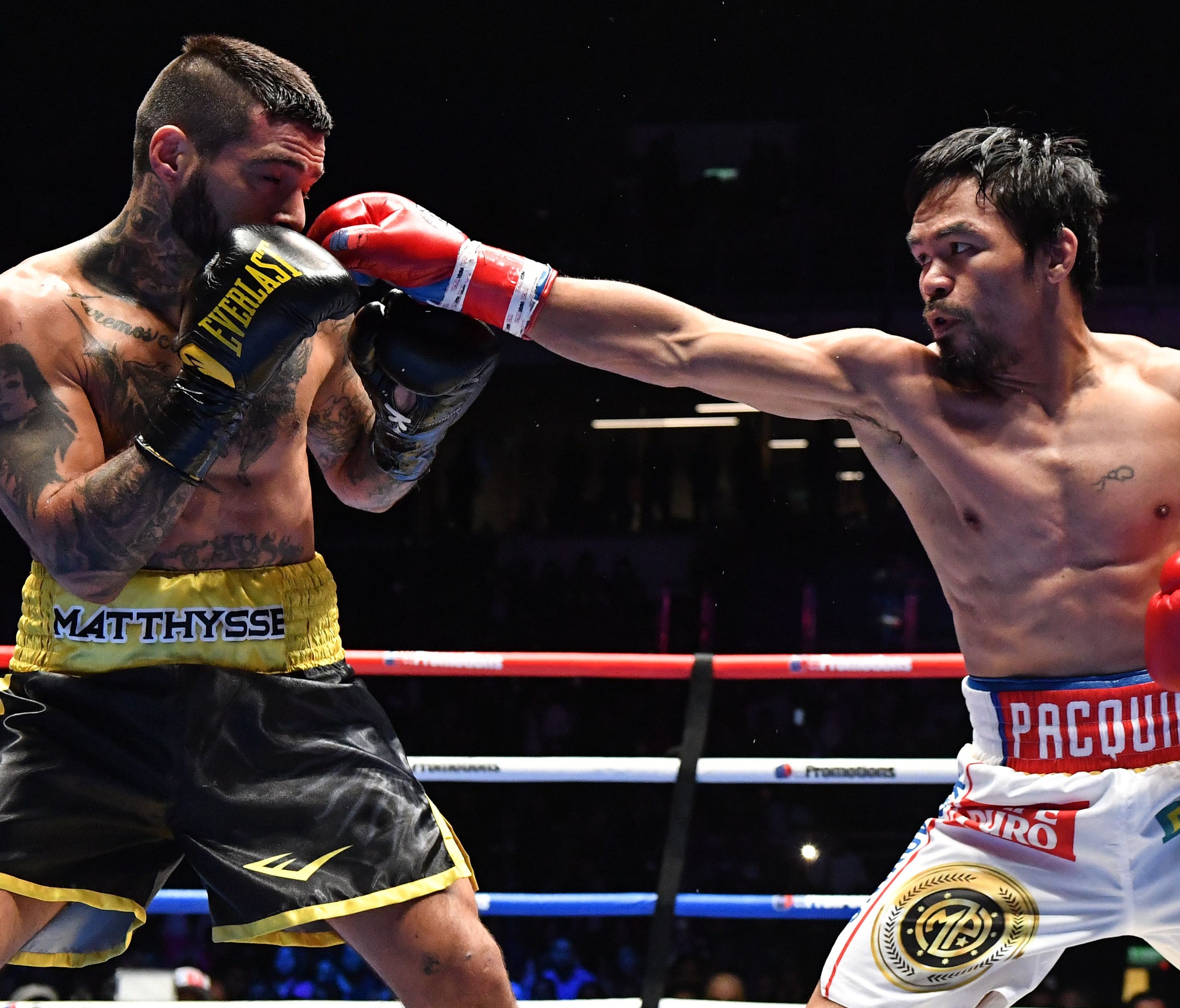 Manny Pacquiao (R) fights Lucas Matthysse during their world welterweight boxing championship bout.