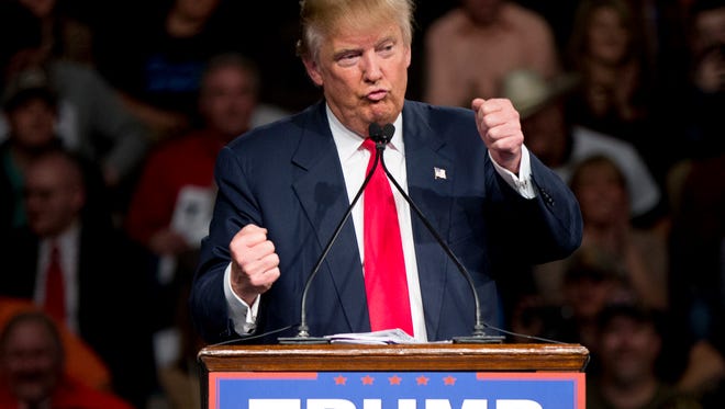 Republican presidential candidate Donald Trump gestures as if driving a car as he speaks about illegal immigrants driving across the boarder during a rally at Sumter Country Civic Center in Sumter, S.C., Wednesday, Feb. 17, 2016. (AP Photo/Andrew Harnik)
