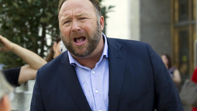 FILE- In this Sept. 5, 2018, file photo conspiracy theorist Alex Jones speaks outside of the Dirksen building of Capitol Hill after listening to Facebook COO Sheryl Sandberg and Twitter CEO Jack Dorsey testify before the Senate Intelligence Committee on 'Foreign Influence Operations and Their Use of Social Media Platforms' on Capitol Hill in Washington. Twitter is permanently banning right-wing conspiracy theorist Jones and his âInfowarsâ show for abusive behavior. (AP Photo/Jose Luis Magana, File)