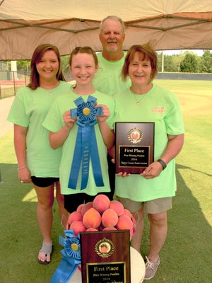 The Knight family was crowned Alabama's top peach growers for the ninth consecutive year Saturday. From left are Andrea, Alissa, Mark and Melissa Knight. Alvin Benn/Special to the Advertiser