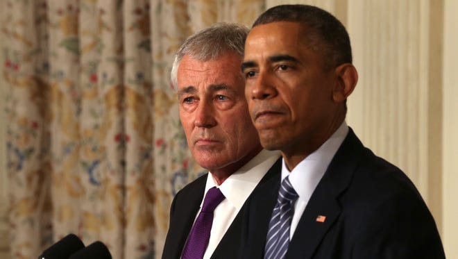 President Obama speaks as Secretary of Defense Chuck Hagel looks on during a press conference announcing Hagel's resignation in the State Dining Room of the White House on Nov. 24, 2014.