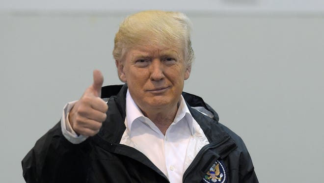 President Donald Trump gives a thumbs up after meeting people impacted by Hurricane Harvey during a visit to the NRG Center in Houston, Saturday, Sept. 2, 2017.