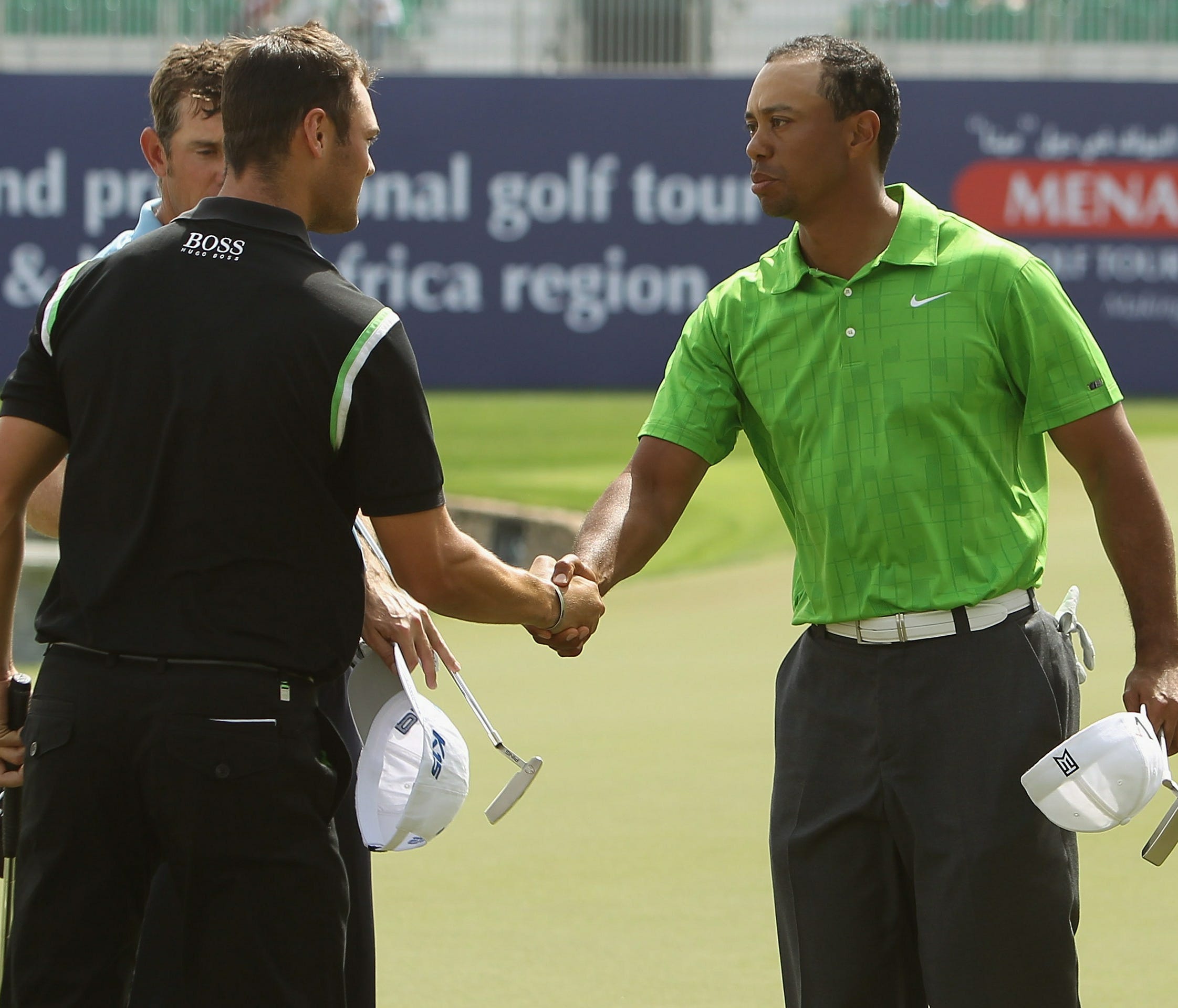 ORG XMIT: 108143329 DUBAI, UNITED ARAB EMIRATES - FEBRUARY 11:  Tiger Woods of the USA (L) and Martin Kaymer of Germany shake hands during the second round for the 2011 Omega Dubai desert Classic held on the Majilis Course at the Emirates Golf Club o