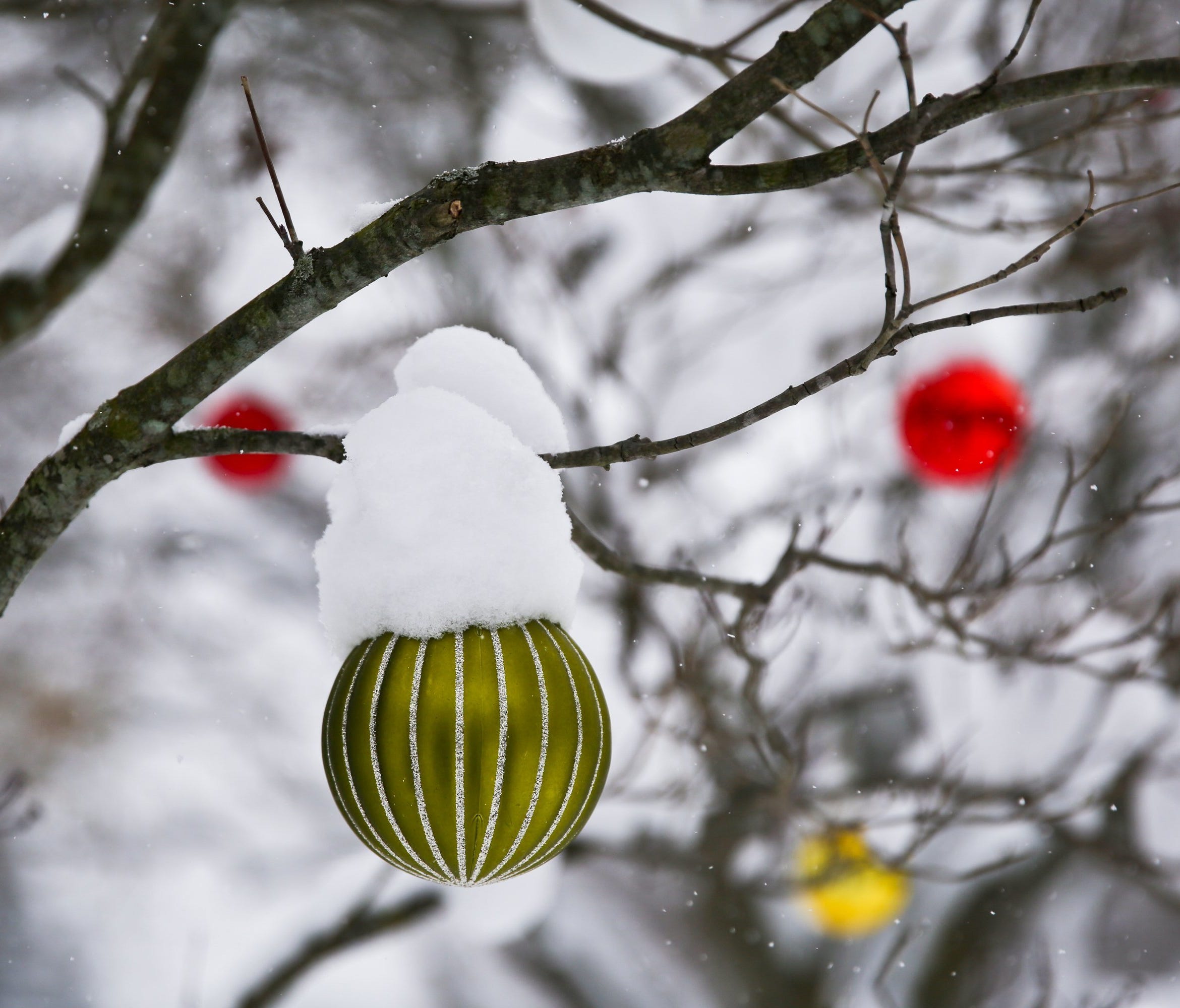 Christmas ornaments hang on a tree in Kalamazoo, Mich., in this 2016 file photo.