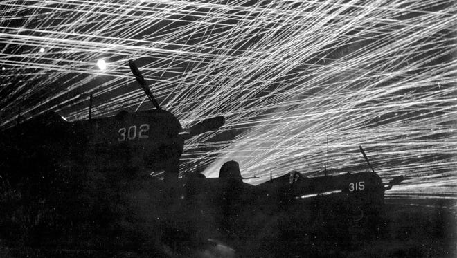 Japanese night raiders are greeted with a lacework of antiaircraft fire by the U.S. Marine defenders of Yontan airfield.