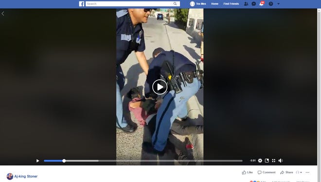 A video posted to Facebook shows an El Paso Police Department officer pulling a gun on a group of boys. Police later handcuff the juvenile shown in this screenshot and place him in the back of a squad car.