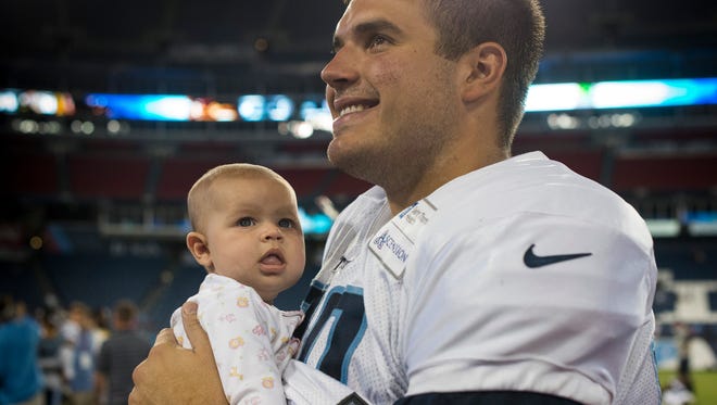 Titans tackle Jack Conklin (78) smiles as he holds his daughter, Riley, after Saturday's scrimmage at Nissan Stadium.