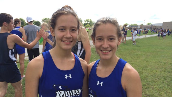 Cros-Lex runners Megan, left, and Miranda Cates pose for a photograph after the Port Huron Invitational last week.